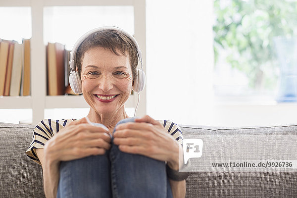 Portrait of smiling senior woman with headphones