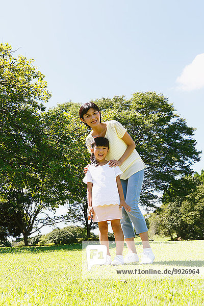 Japanese mother and daughter in a city park
