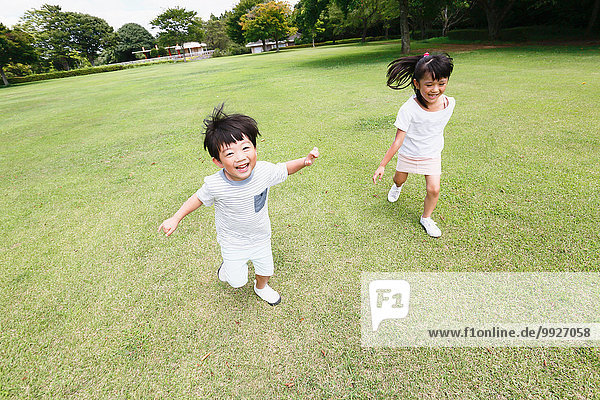 Happy Japanese kids in a city park