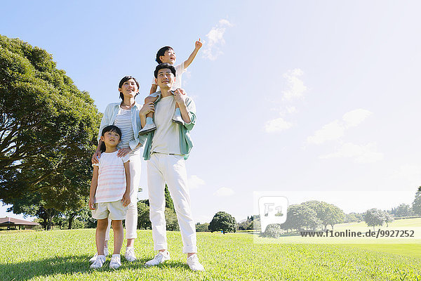 Happy Japanese family in a city park