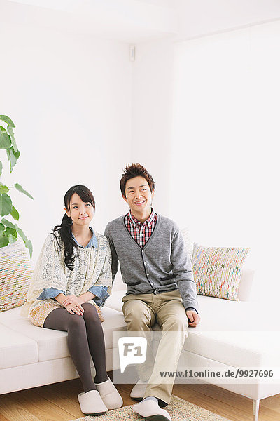 Young adult couple relaxing on the sofa