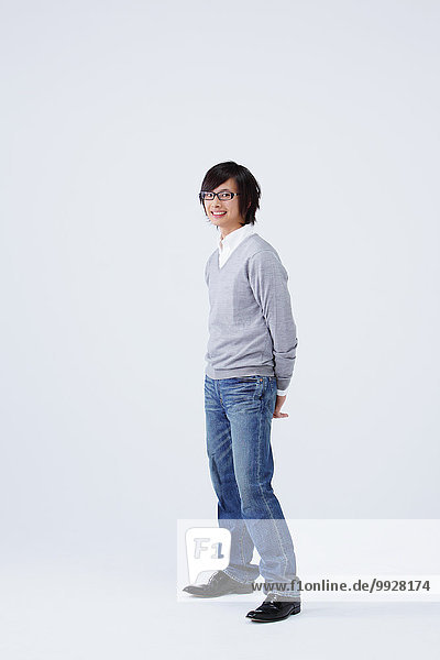 Full body view of young man wearing jeans