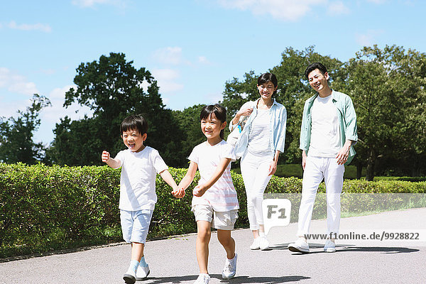 Happy Japanese family in a city park