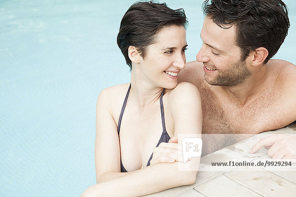 Couple relaxing together in pool