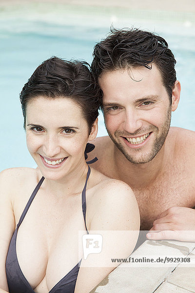 Couple relaxing together in pool  portrait