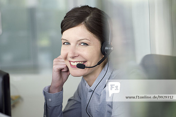 Businesswoman wearing headset during conference call  portrait