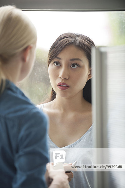 Woman talking with colleague in office
