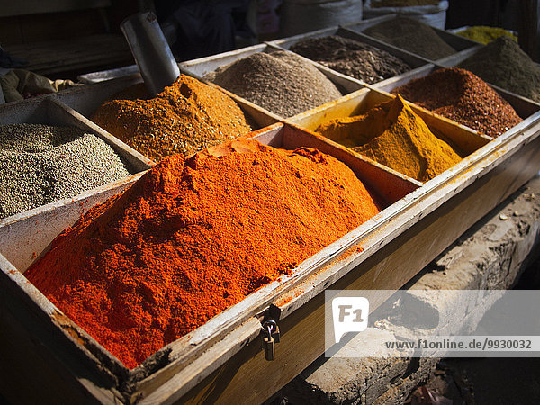 Bins of dried spices for sale in market