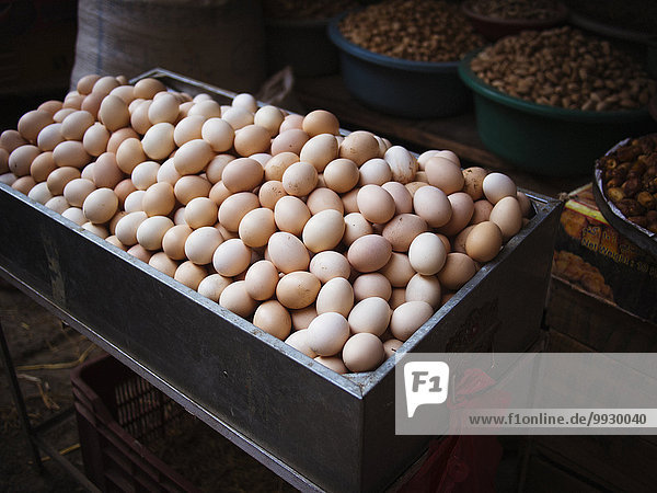 Bin of fresh eggs for sale in market