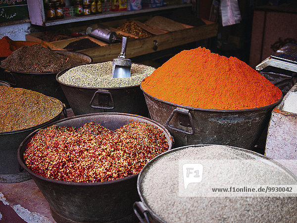 Buckets of dried spices for sale in market