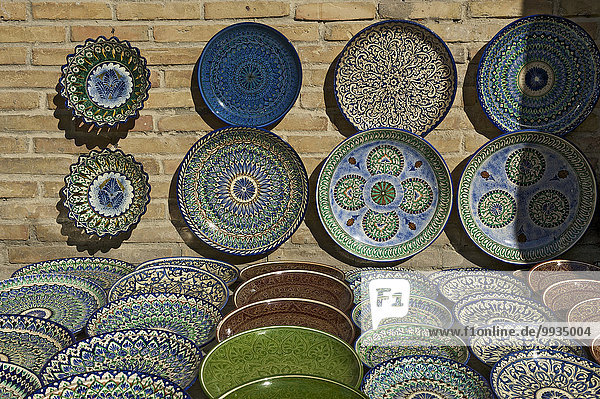 Asia  Uzbekistan  Central Asia  silk road  outside  day  Buxoro  Bukhara  market stall  state  market  sales  stand  souvenir  traditional  plate  pottery  ceramics  nobody