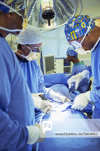 Surgeons performing surgery in operating room
