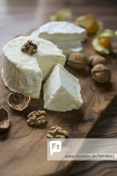 Close-up of cheese and walnuts on chopping board  Germany