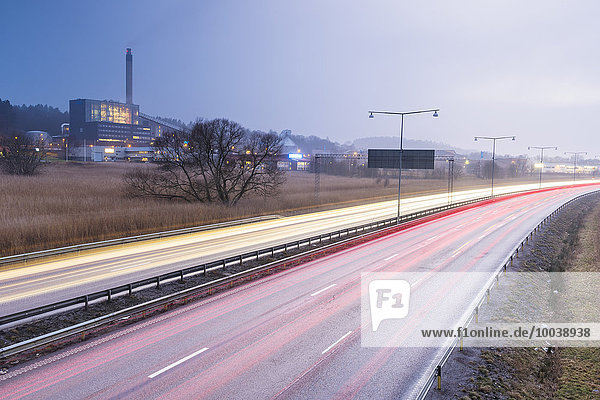 Car lights on road at dusk