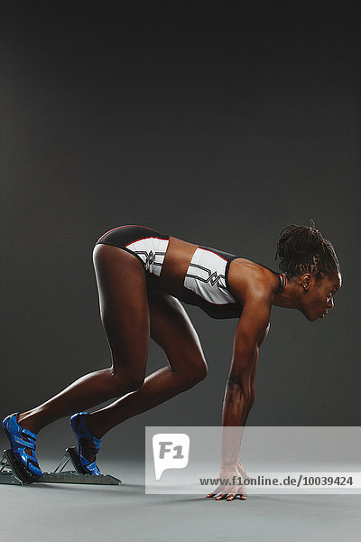 African Woman Runner Preparing To Start