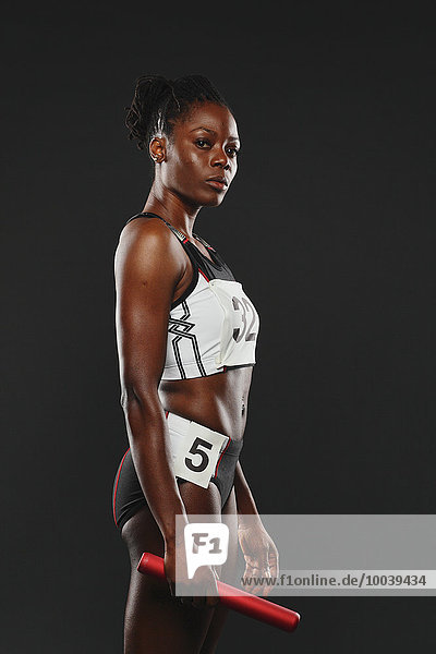 Portrait of African Female Athlete Holding Relay Baton