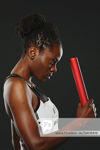 Female Athlete Holding Relay Baton  Focused