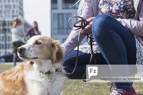 Close-up of teenage girl stroking her dog  Munich  Bavaria  Germany