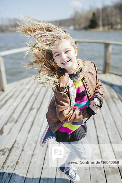 Jumping girl on jetty