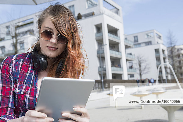 Young woman using a digital tablet  Munich  Bavaria  Germany