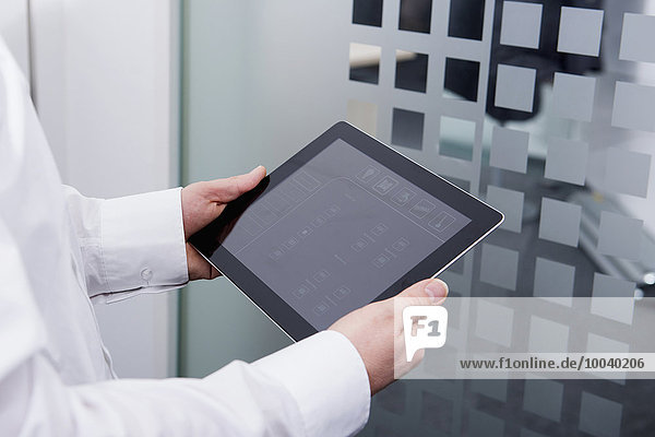 Man operating digital tablet in office Munich Bavaria Germany