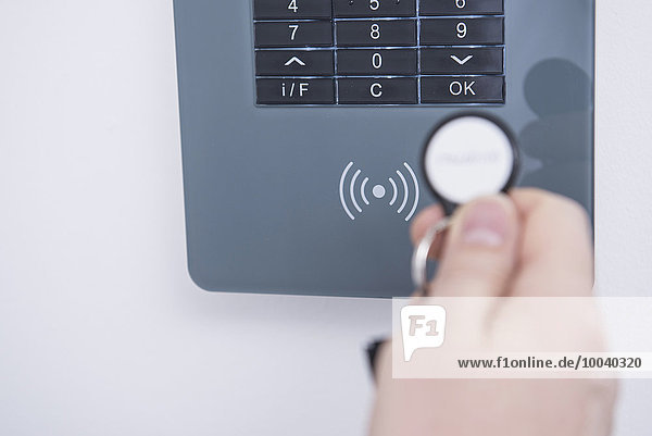 Man's hand opening door protected with security system Munich Bavaria Germany