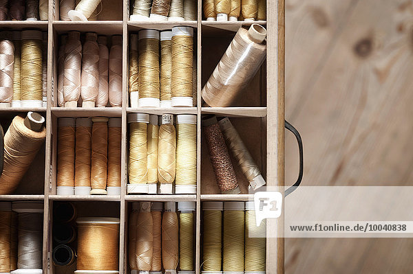Multi Colored reels of sewing threads in drawer  Bavaria  Germany