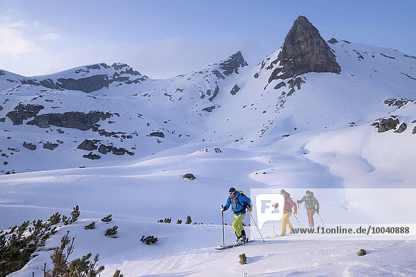 Ski mountaineers climbing on snowy mountain Tyrol Austria