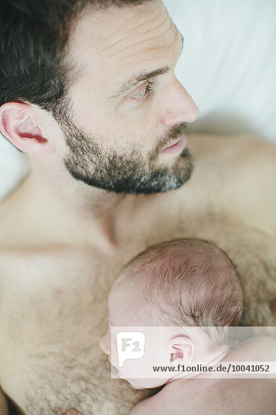 Mid adult man with newborn baby