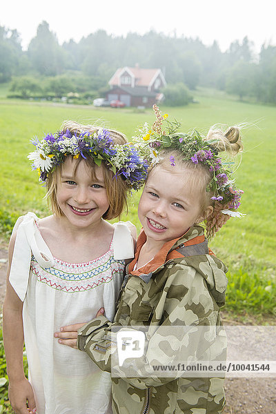Smiling girls wearing flower wreath