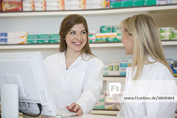 Two female pharmacists communicating