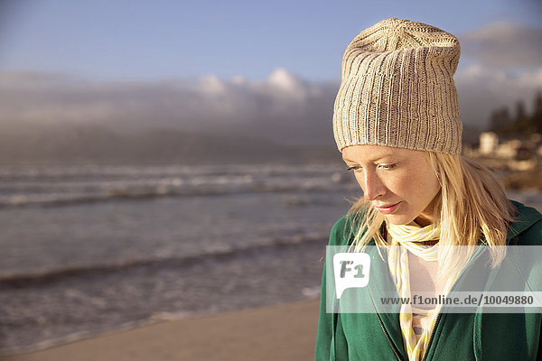 Thoughtful young woman on beach