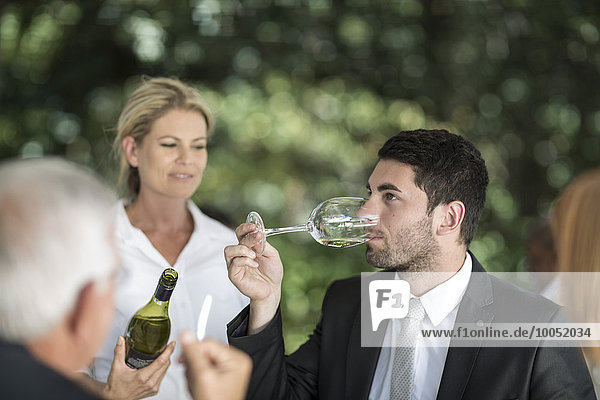 Client in restaurant tasting white wine