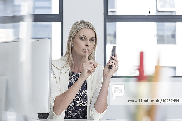 Businesswoman in office talking on the phone