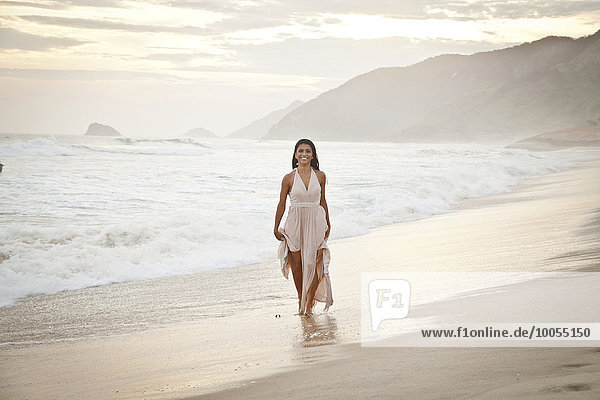 Mid adult woman walking along beach