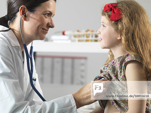 Doctor bonding with young girl during consultation