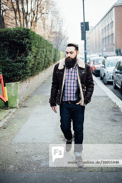 Young bearded man on pavement