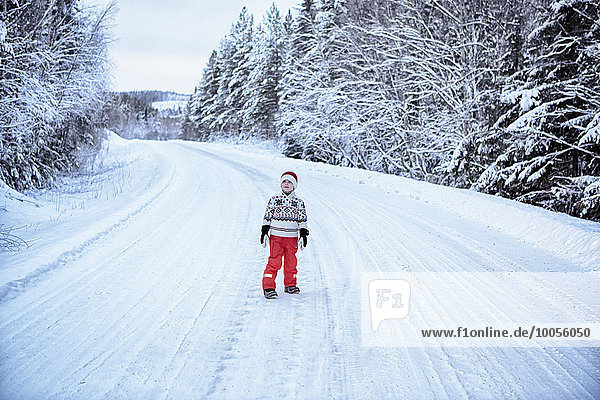 Boy looking up from snow covered highway  Hemavan  Sweden