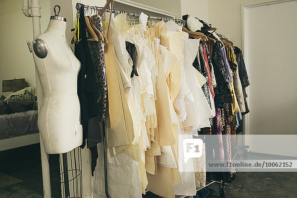 Tailors dummy and clothes rail in fashion studio