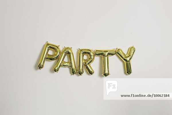Word party in gold inflatable capital letters