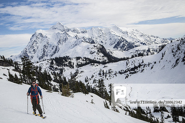 Young male skier moving along mountainside  Mount Baker  Washington  USA