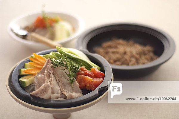 Asian food in steamer lid