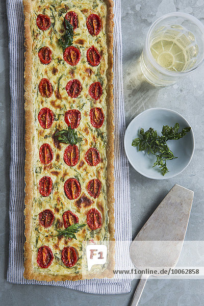 Quiche mit Tomaten- und Kräutergarnitur über dem Kopf