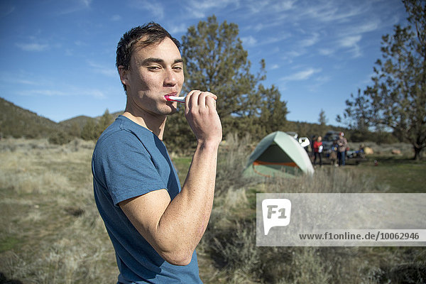 Man brushing teeth at camp  Smith Rock State Park  Oregon