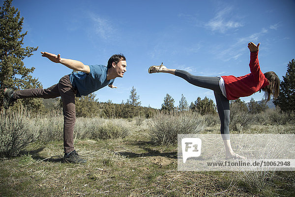 Couple practising yoga  Smith Rock State Park  Oregon