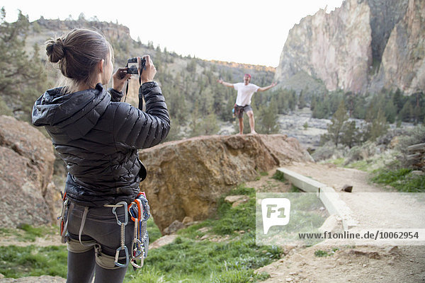 Rock climber taking photograph  Smith Rock State Park  Oregon