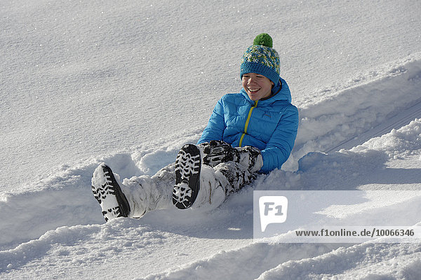 Boy on a minibob in deep snow  Bad Heilbrunn  Upper Bavaria  Bavaria  Germany  Europe