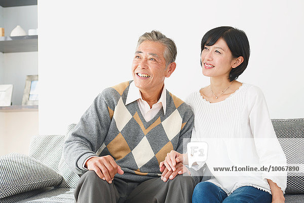 Japanese senior and daughter on the sofa