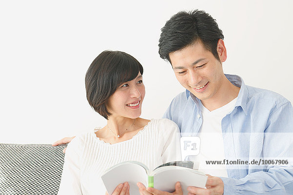 Japanese couple on the sofa with book
