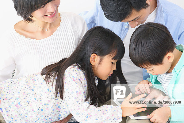 Japanese family playing with tablet